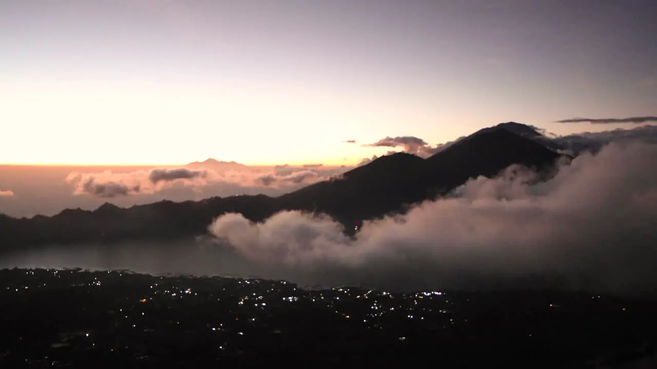 TIMELAPSE Clouds rolling in through valley and blocking view of mountain at sunrise