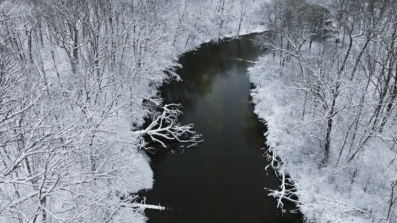 Aerial view from a drone capturing the serene winter stillness of the snow-covered Huron River Valley