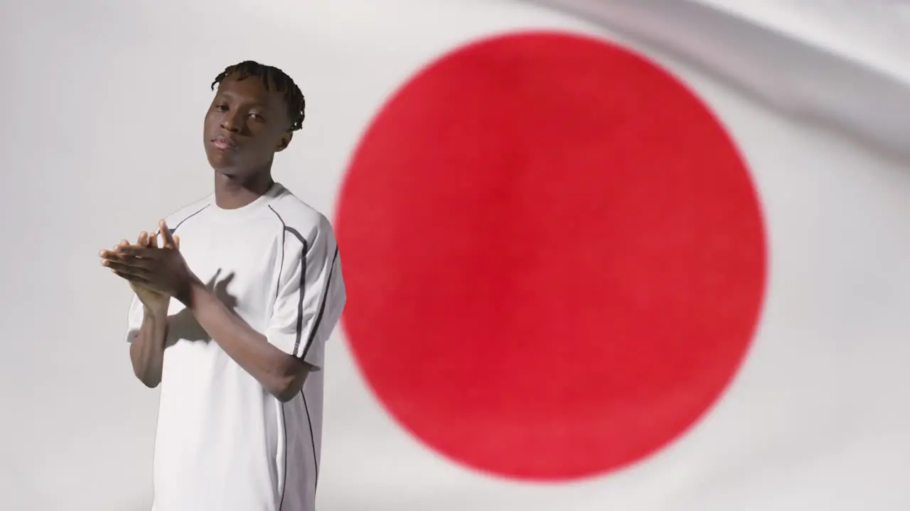 Young Footballer Posing In Front of Japan Flag