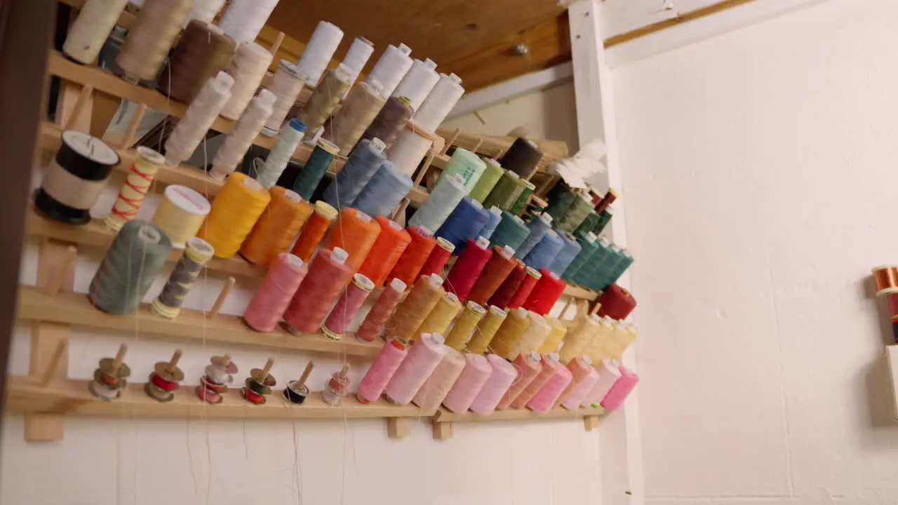 Cotton thread spools on wall in seamstress studio