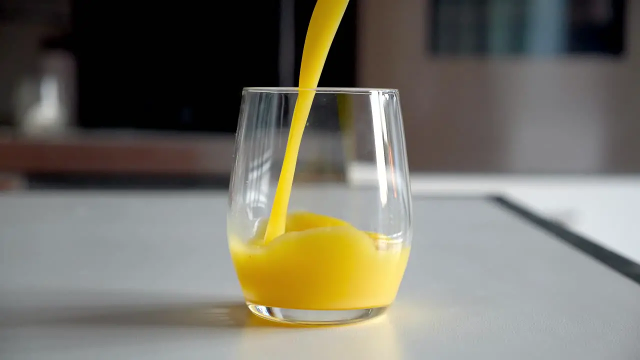 Slow Motion Glass filled with orange juice 4k 60fps