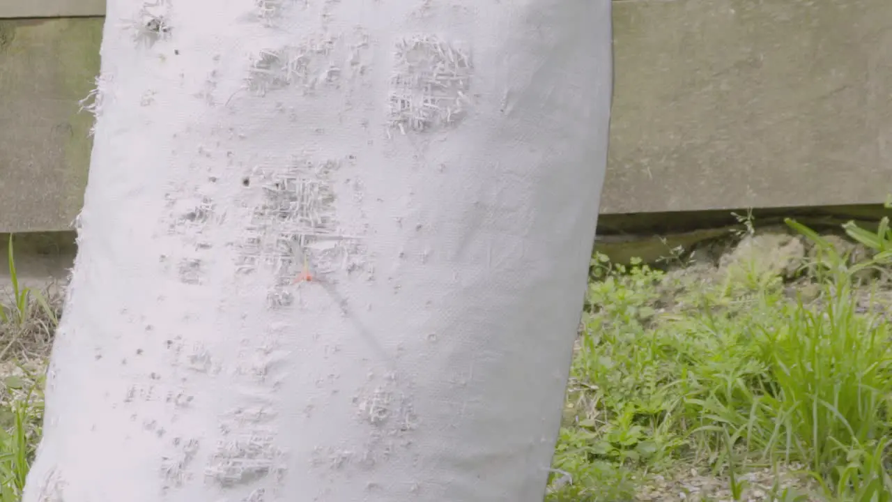 A slow motion shot of an arrow being fired into an archery bag