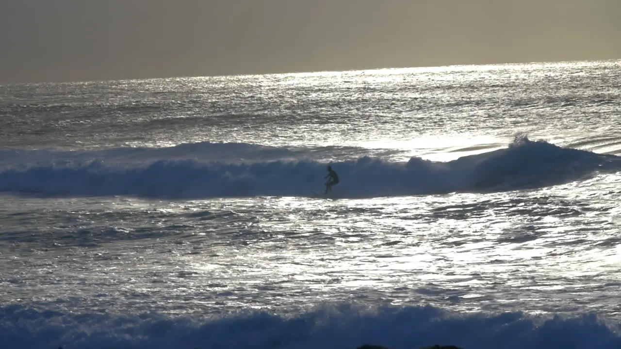 Silhouette Of Surfer Surfing In Ocean At Sunrise From Bronte Beach In Sydney NSW Australia