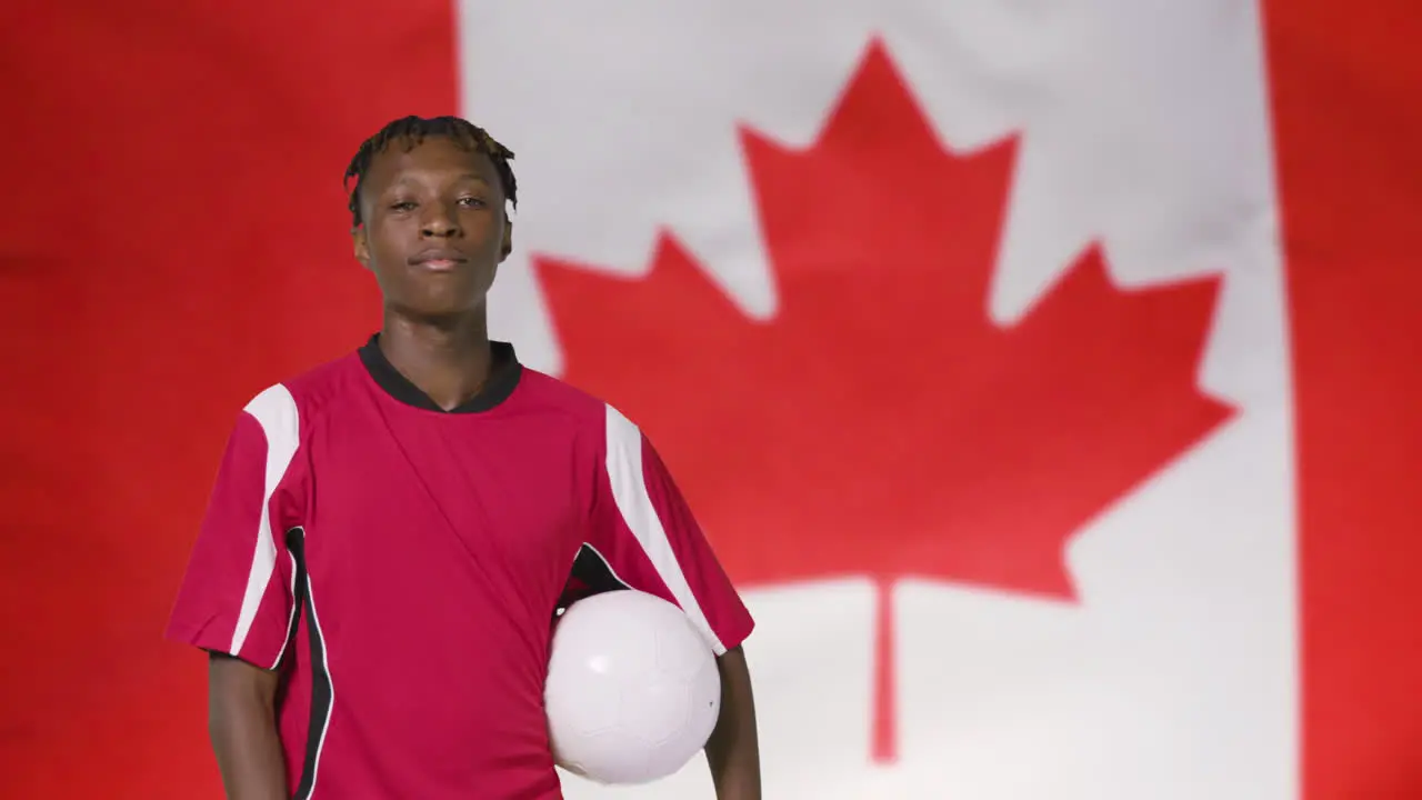 Young Footballer Posing In Front of Canada Flag 01