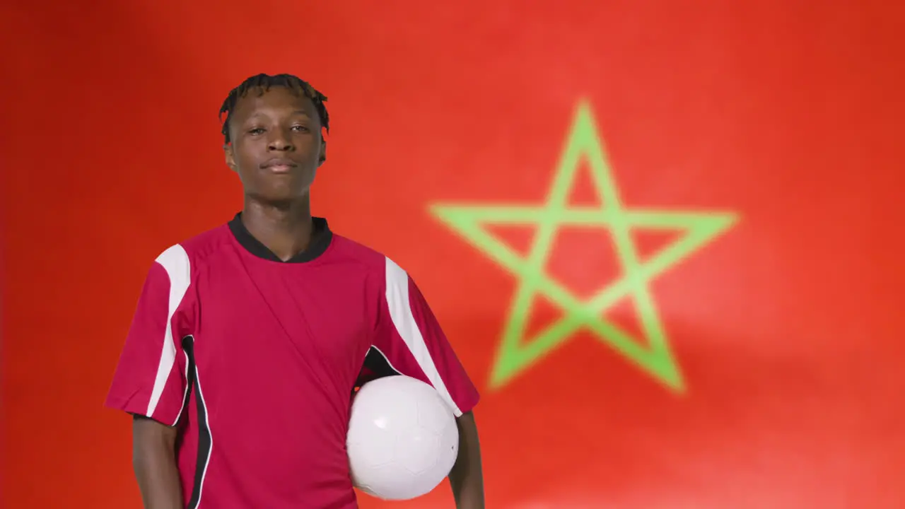 Young Footballer Posing In Front of Morocco Flag 01