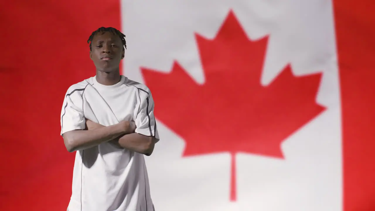 Young Footballer Posing In Front of Canada Flag 02