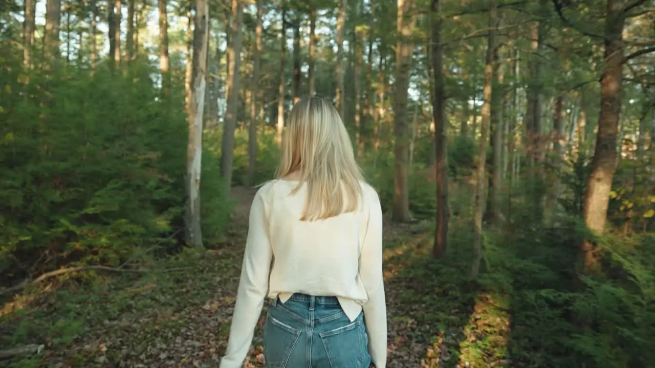 White shirt girl walking through the forest