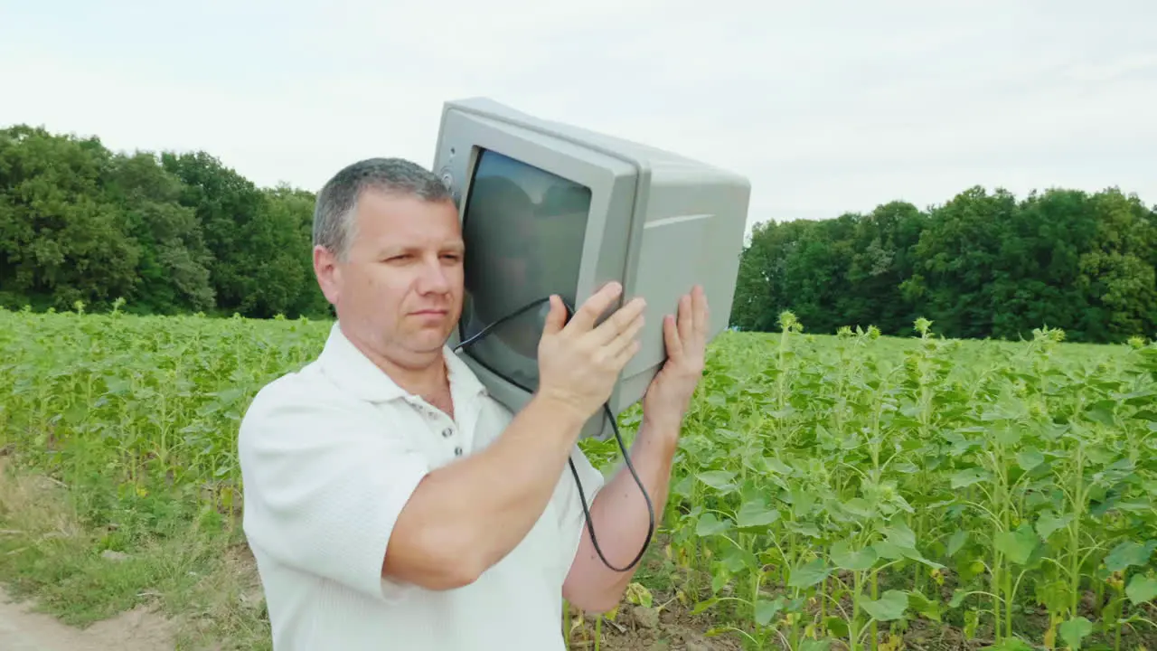 A Cool Middle-Aged Man Carries An Old Tv Set On His Shoulder 2