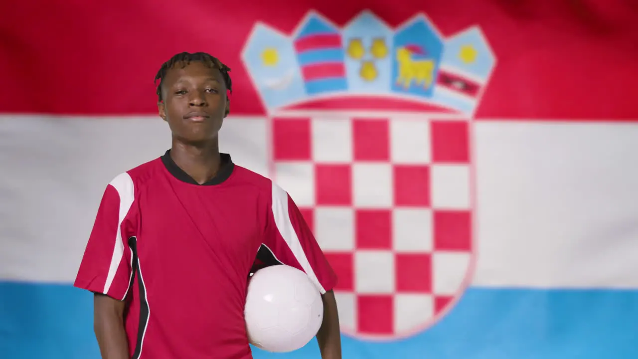 Young Footballer Posing In Front of Croatia Flag 01