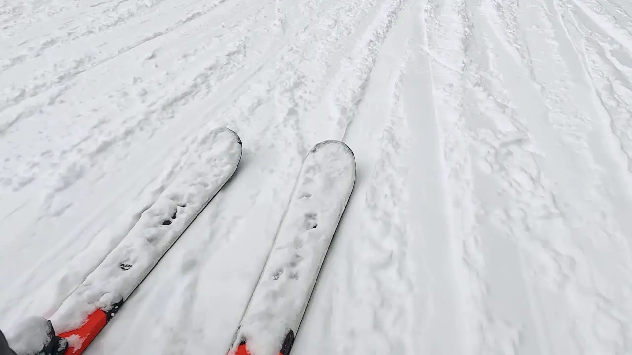 POV Shot Of Skier Skiing Down Snow Covered Slope Looking Down At Skis 1