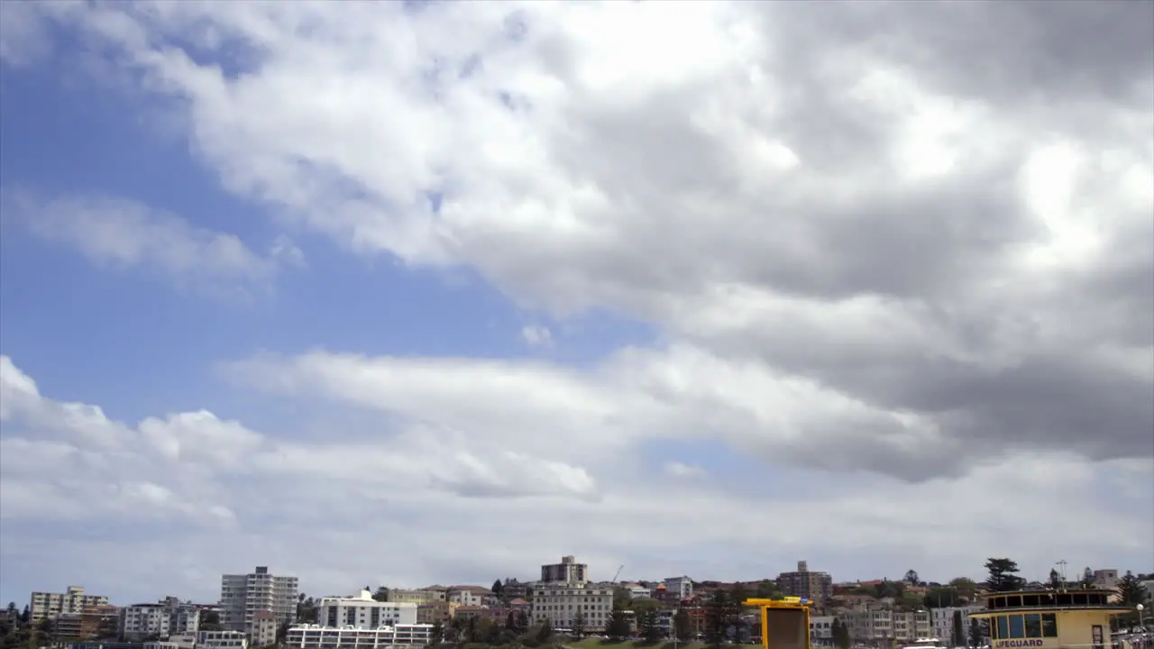 Time Lapse Thick white and grey clouds moving across the sky above Bondi Beach Sydney Australia