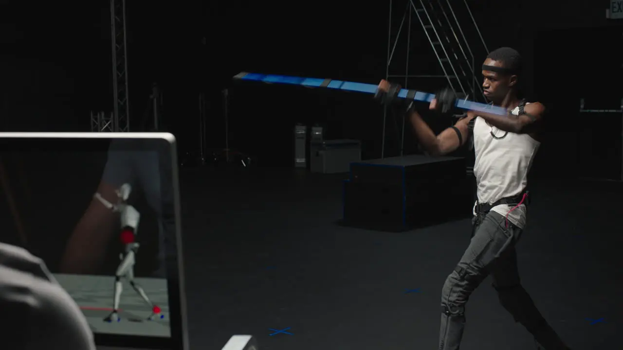 mocap man wearing motion capture suit in studio performing bo staff sword fighting martial arts actor wearing mo-cap suit for 3d character animation for virtual reality gaming industry