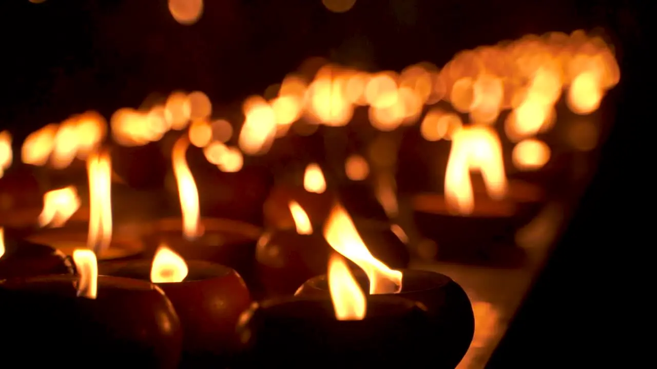 Close up view of oil candles burning at night