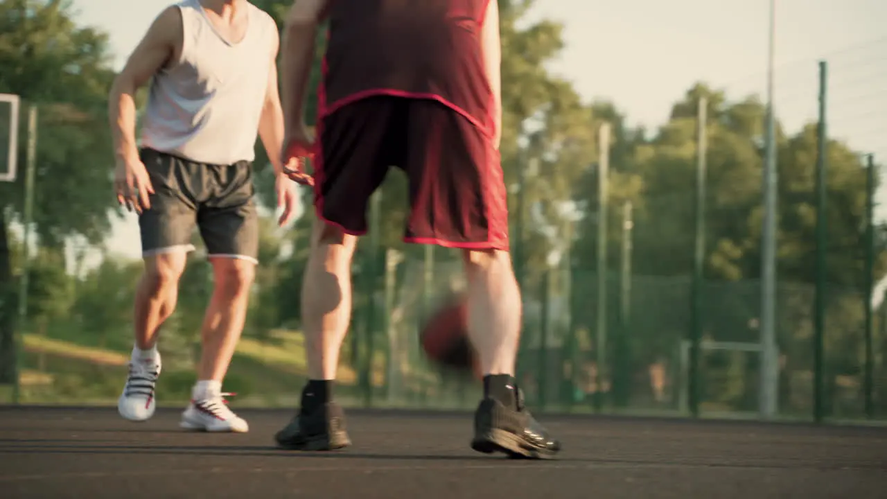 Two Male Basketball Players Dribbling In Outdoor Basketball Court 1