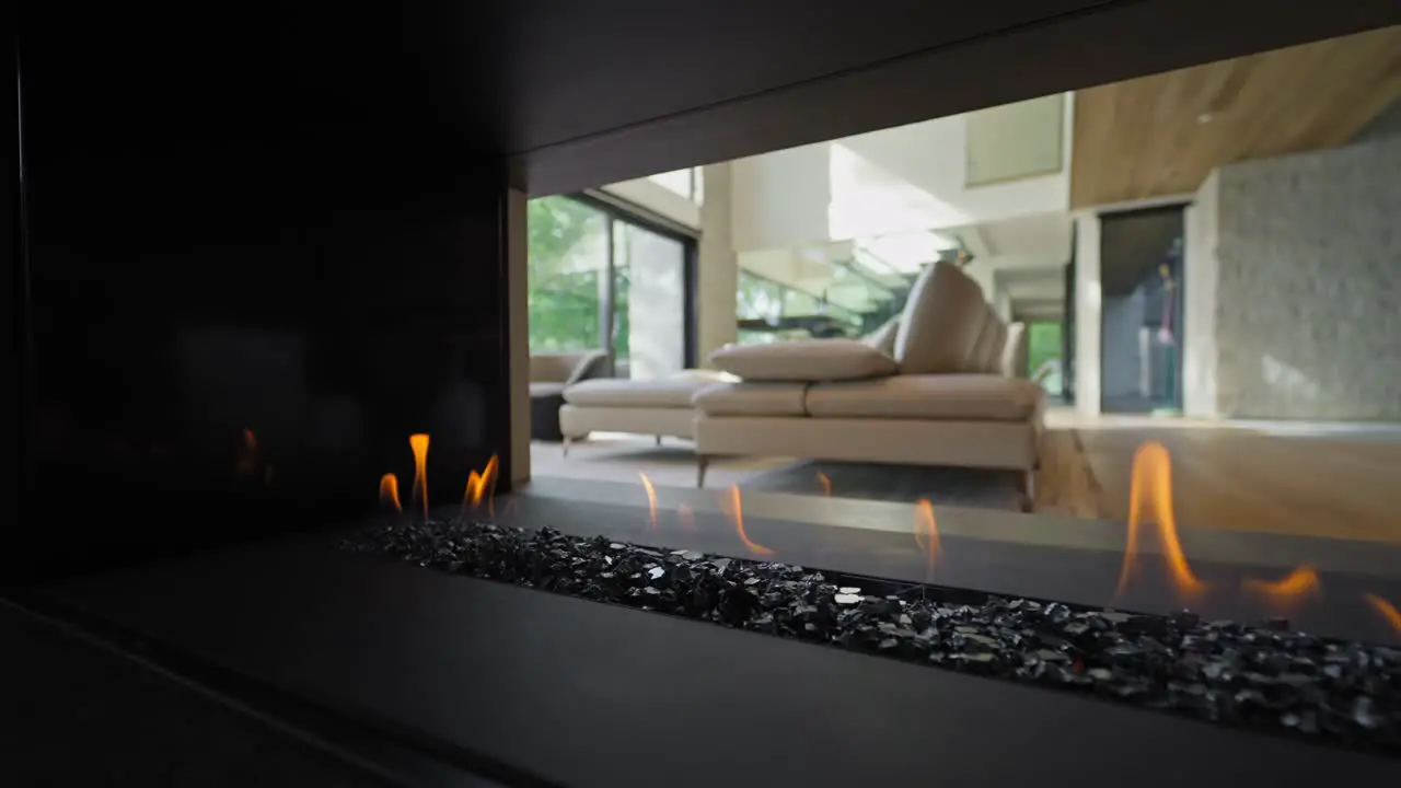 3-sided Modern Gas Fireplace Open on Three Sides in Luxury House Interior side dolly in slow motion