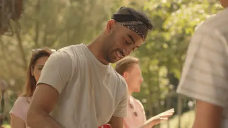 Medium Shot of a Festival Goer Getting Hot Dog from Fast Food Stand