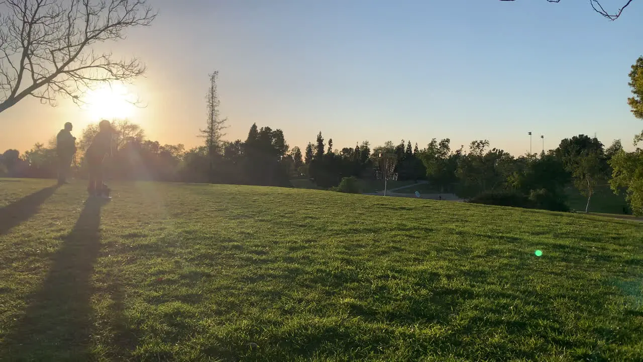 Friends playing frisbee at the park