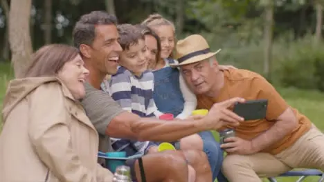 Medium Shot of Family Taking a Selfie On Camping Trip 01