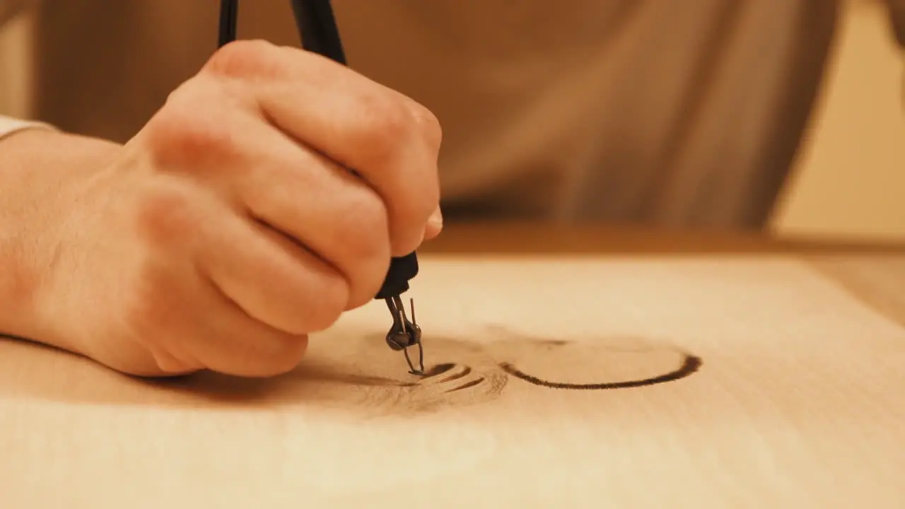 Close up footage of artist woodburning a duck