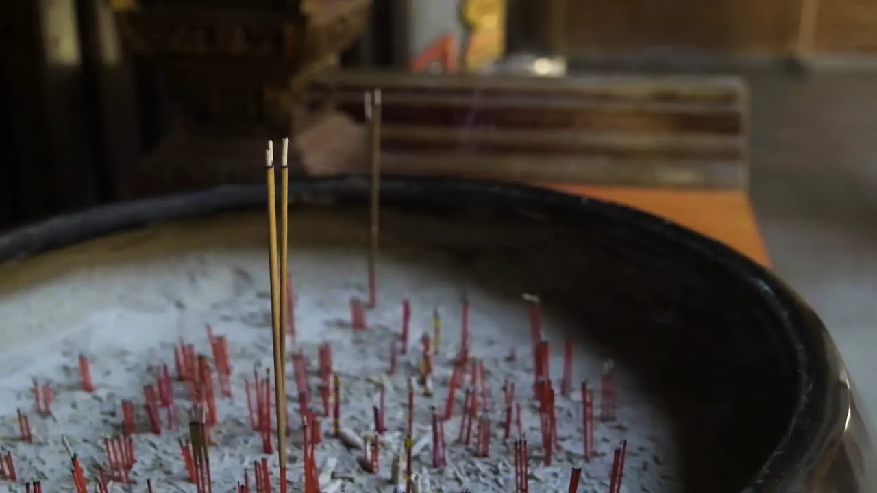 Incense slowly burning in quiet Chinese Taoist temple