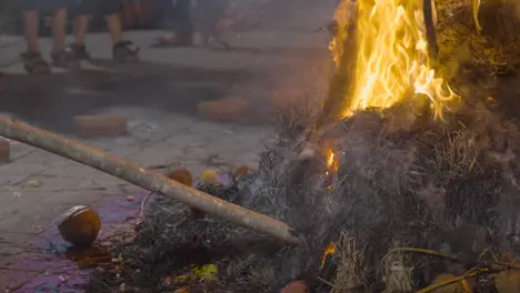 Close Up Of People Celebrating Hindu Festival Of Holi Burning Coconuts On Bonfire In Mumbai India