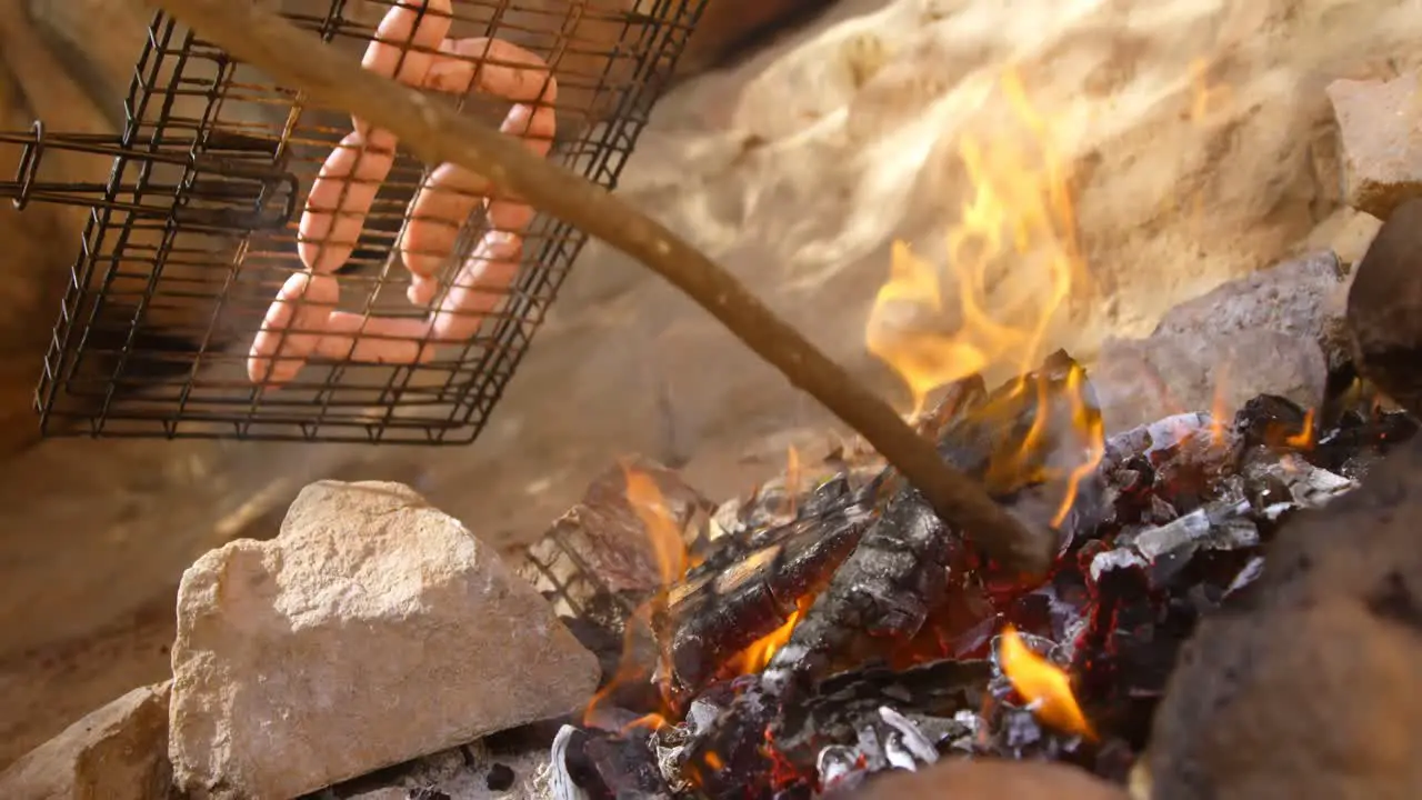 Hot dog being prepared on campfire 4k