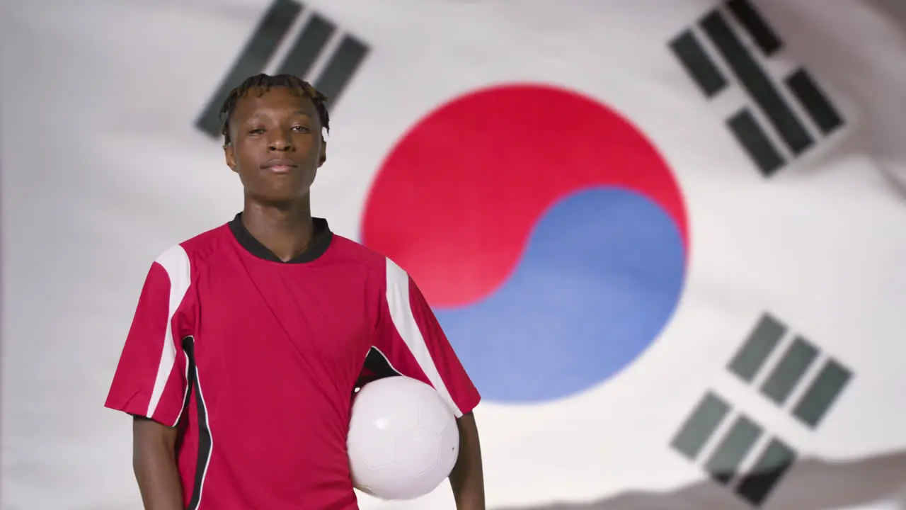 Young Footballer Posing In Front of South Korea Flag 01