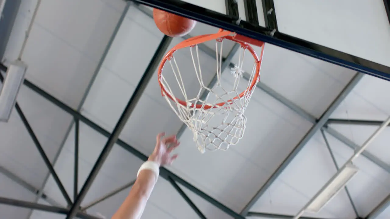 Athlete scoring during a basketball game with copy space