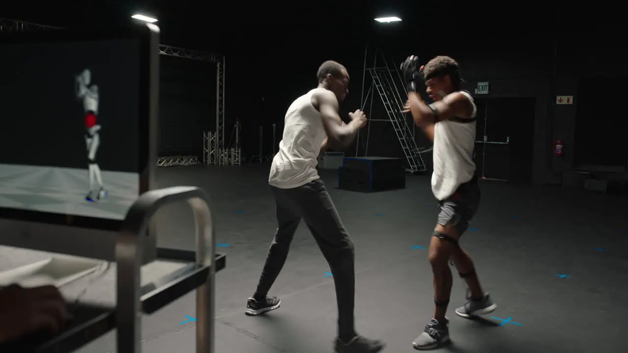 martial artist wearing motion capture suit in studio performing martial arts fighting wearing mo-cap suit for 3d character animation for augmented reality technology