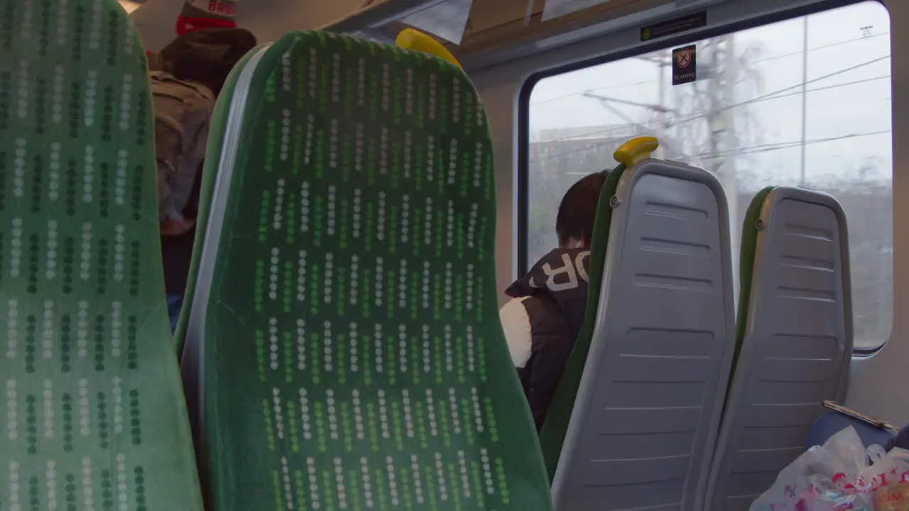 Man walking down aisle of train