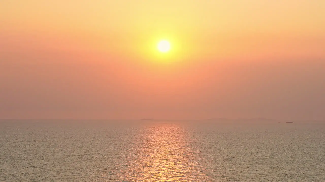 Spectacular sunset over sea and vibrant pink-orange colorful sky