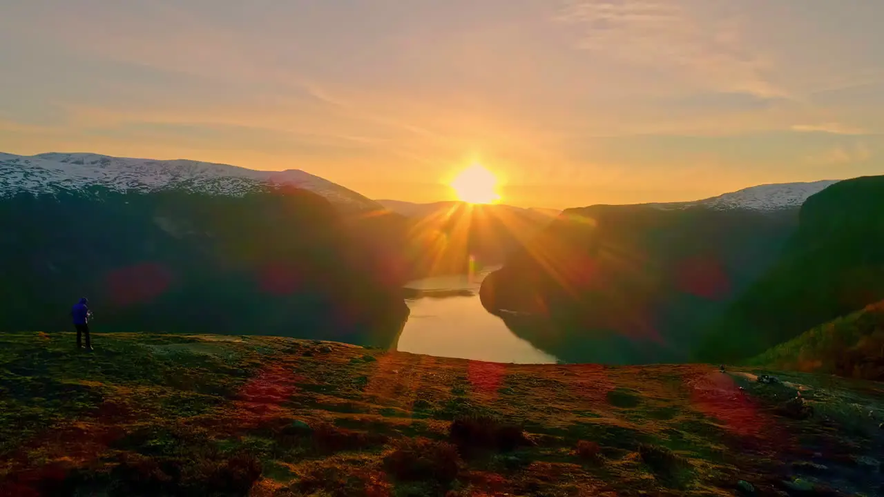 Isolated man contemplating amazing landscape of fjord at sunset Norway