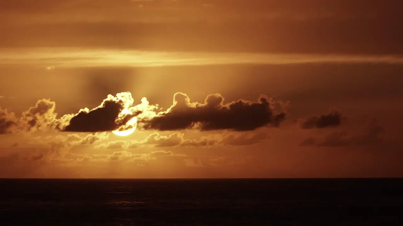 Beautiful Sunset Time Lapse Above the Sea with Orange Sky and Moving Clouds