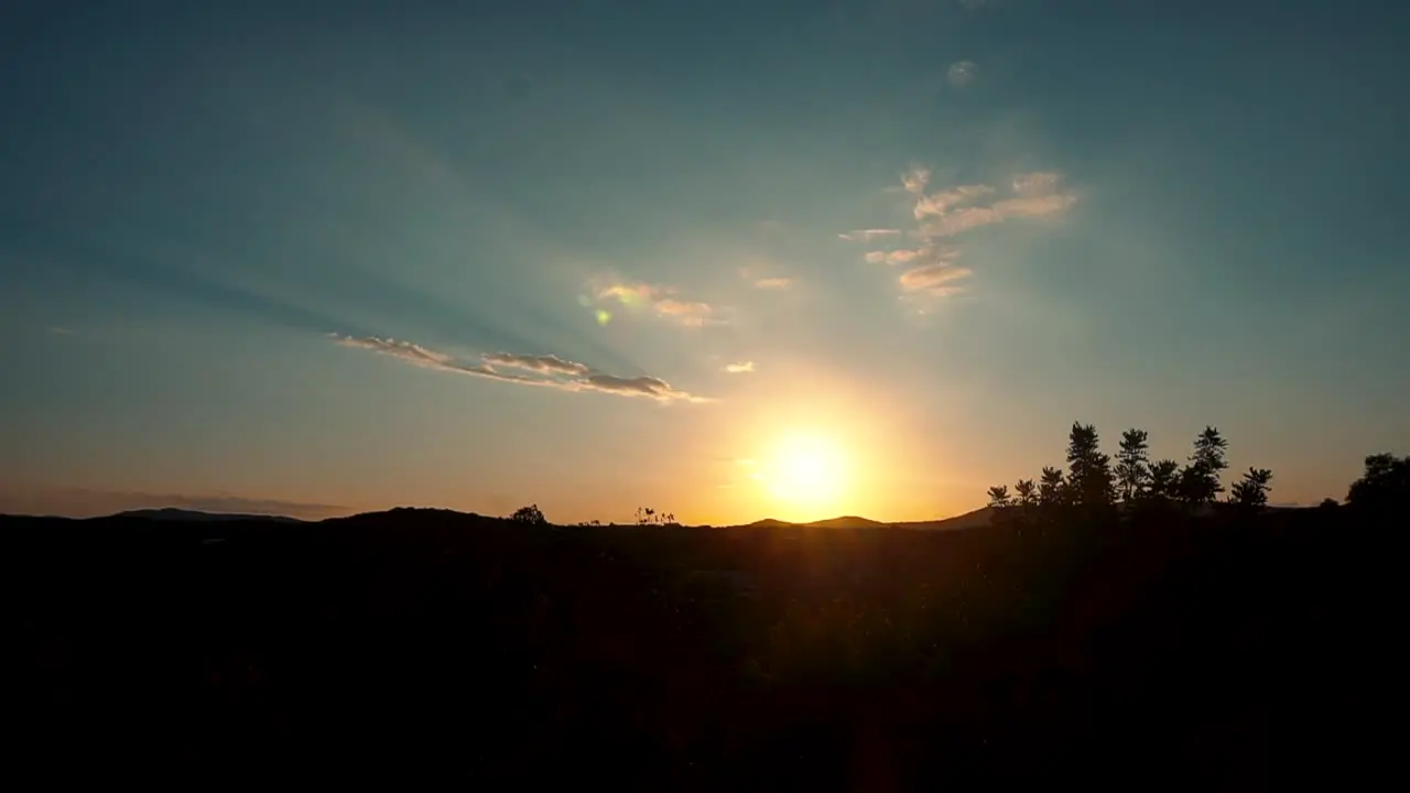 Bright Sunset Peaking Through Hills With Clouds In Blue Sky In Forest Park Of Spain