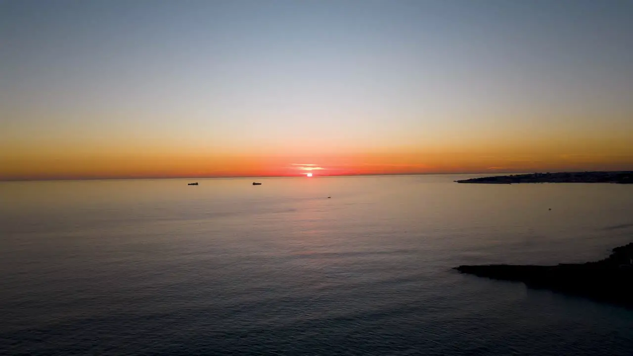 Timelapse Aerial View Flying Over Ocean Into Dramatic Sunset near Cascais bay