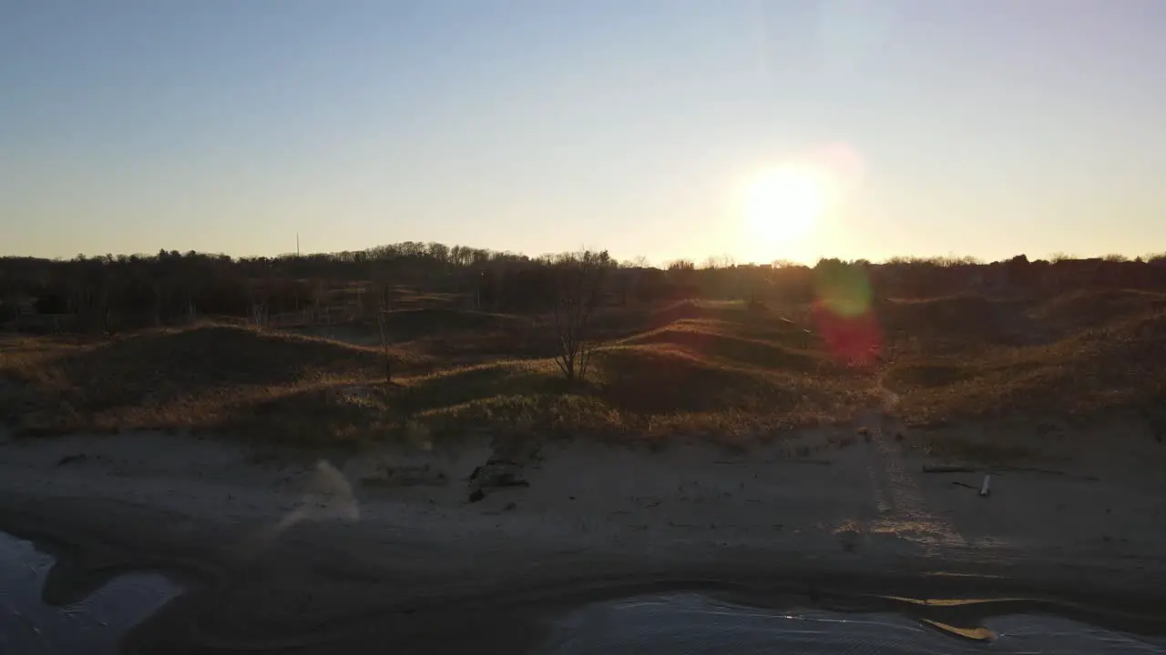 Small dunes bathed in warm light at sunset