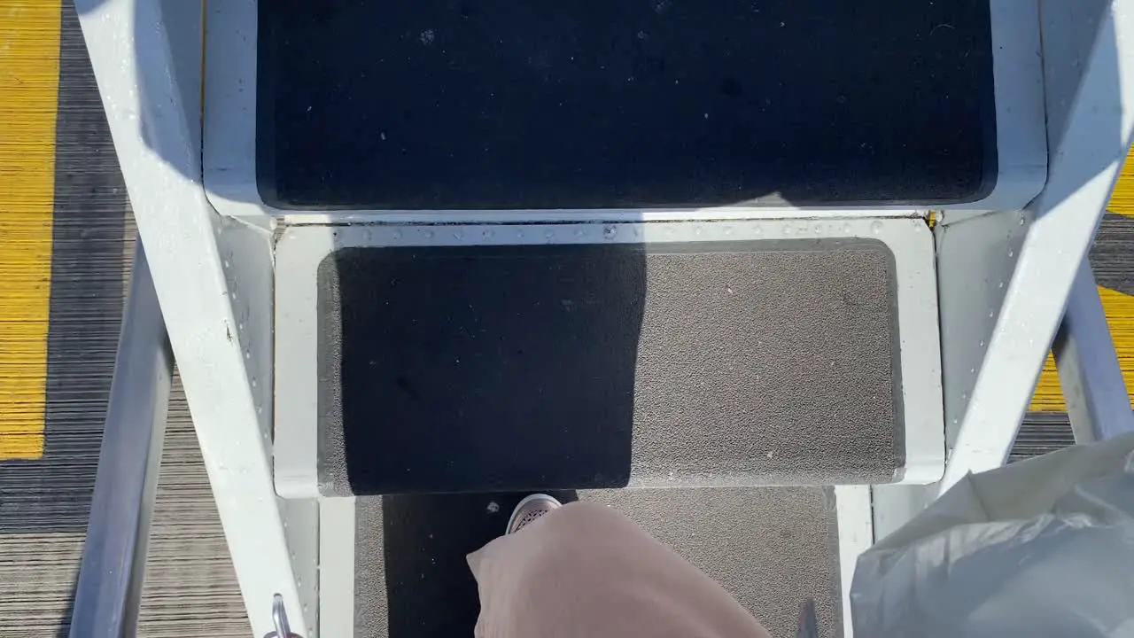 A person boarding and walking up the stairs onto a big Ryanair boeing airplane in Bristol international airport holiday vacation time 4K shot