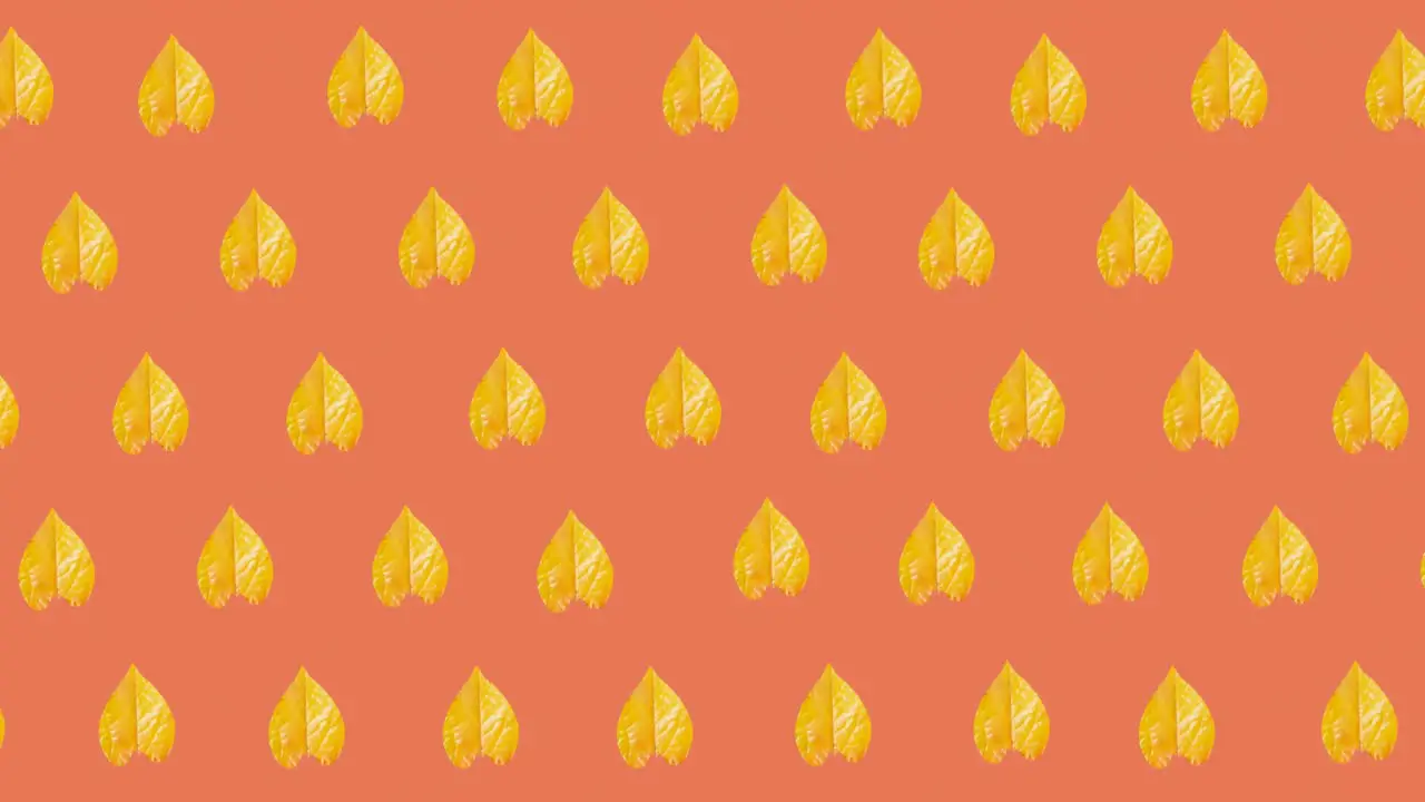 Animation of multiple yellow autumn leaves over orange background