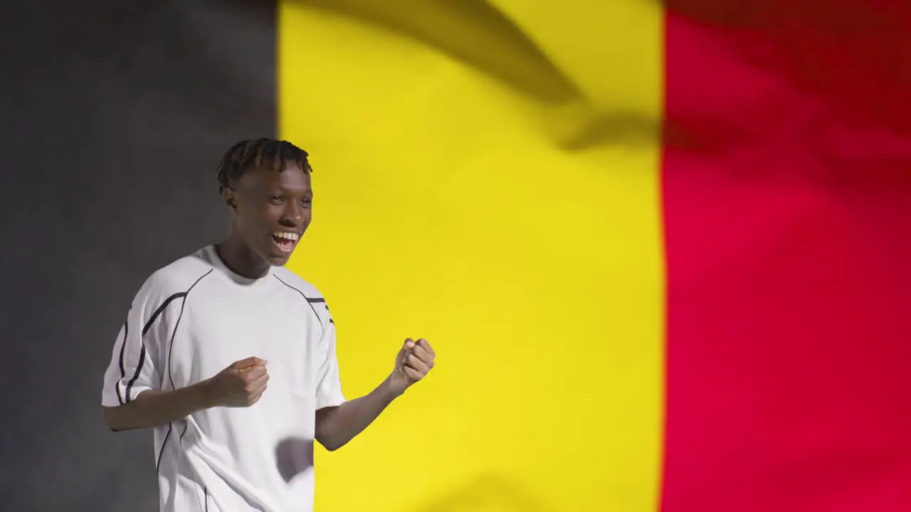 Young Footballer Celebrating to Camera In Front of Belgium Flag 02