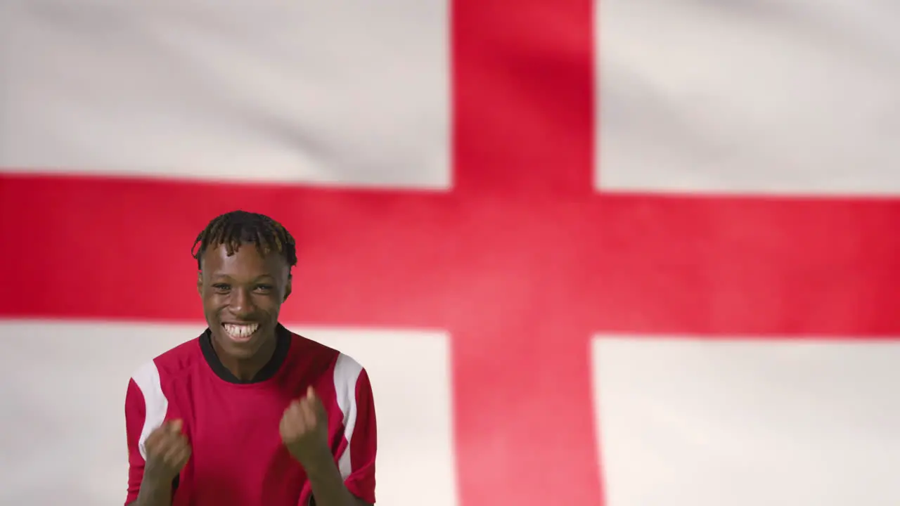 Young Footballer Celebrating to Camera In Front of England Flag 01