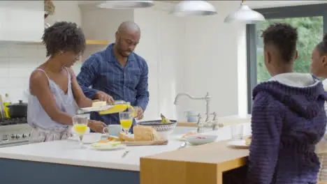 Family Having Breakfast Together at Kitchen Island 