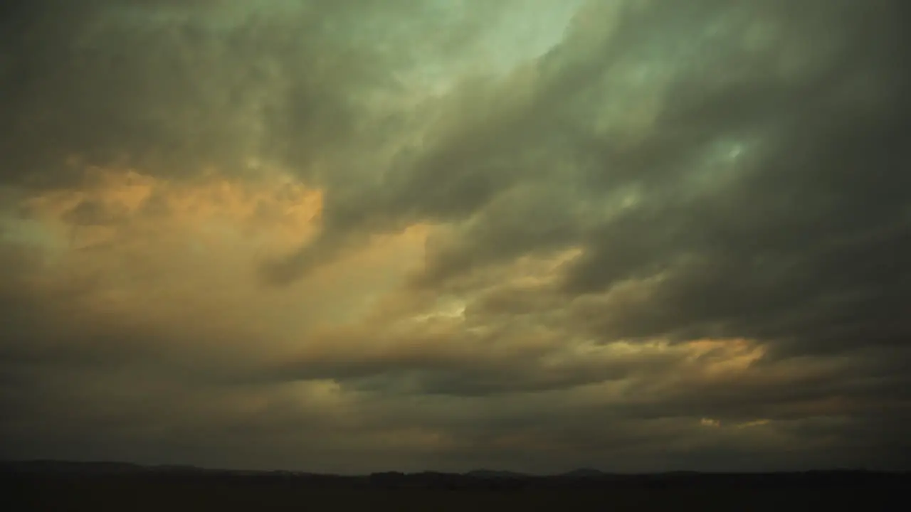 Colorful clouds swiftly pass overhead in stunning sunset time lapse