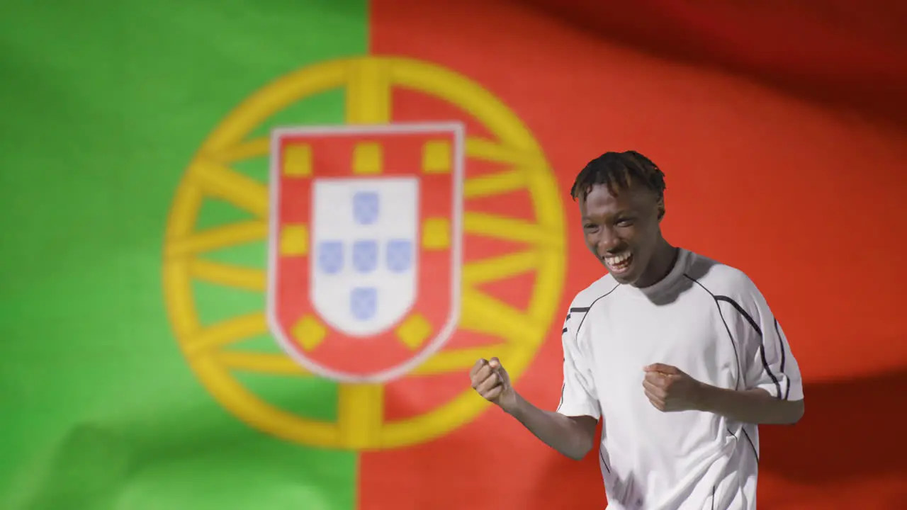 Young Footballer Celebrating to Camera In Front of Portugal Flag 02