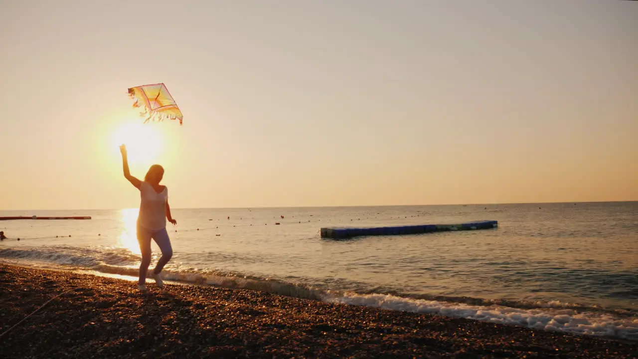 Woman With Kite Runs Along The Beach Steadicam Shot