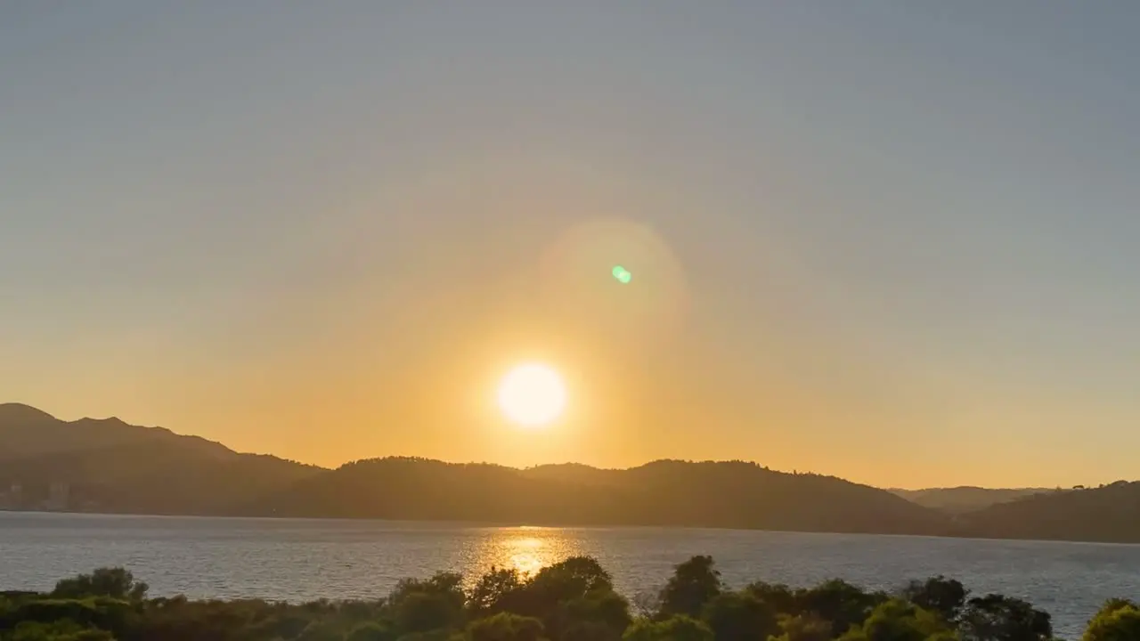 Aerial view over Beautiful Sunset at Outão Setúbal Portugal drone view from Troia of orange sunset with sea and shore