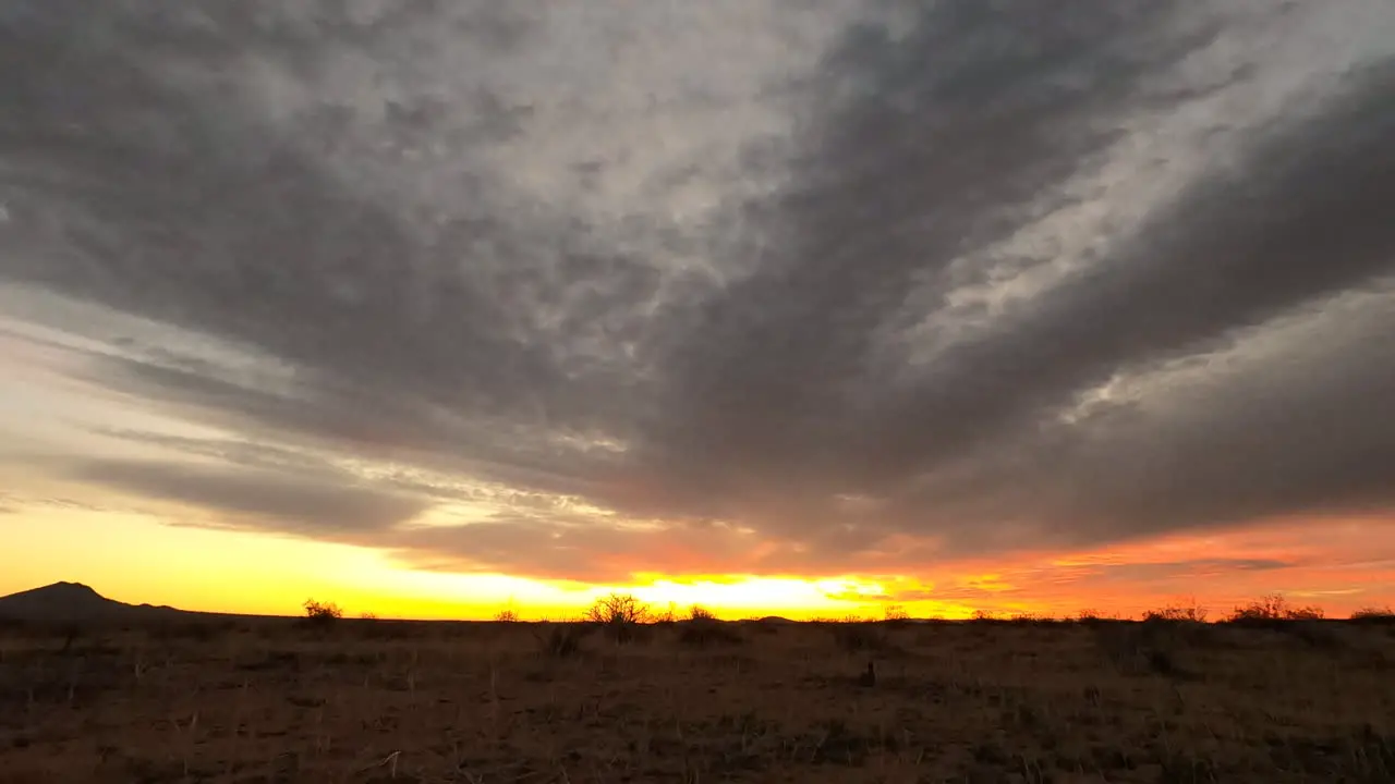 Landscape time lapse of sunrise in Mojave Desert with clouds dissipate