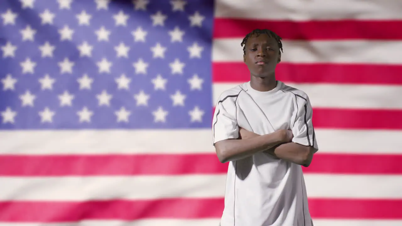 Young Footballer Walking to Camera In Front of USA Flag 01