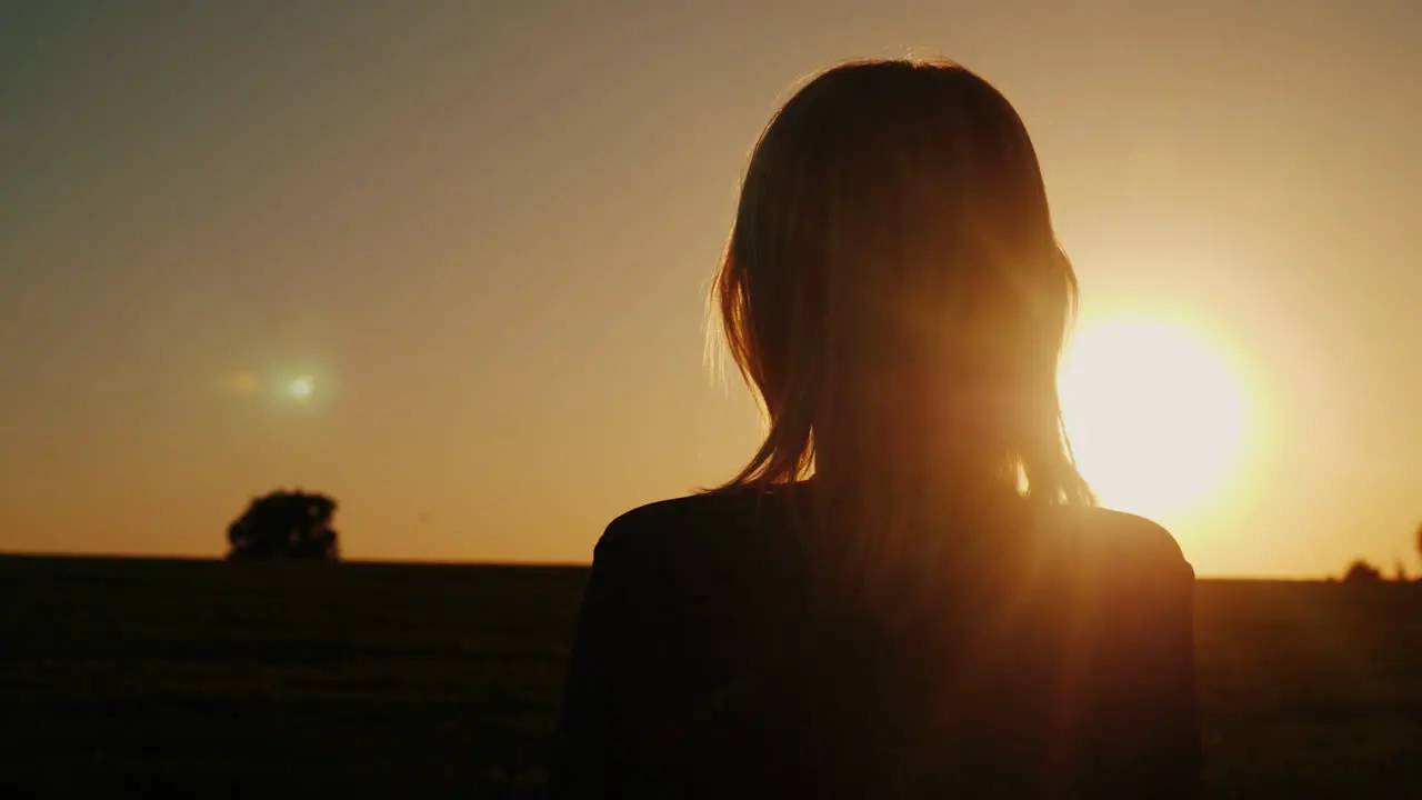 A Thoughtful Woman Looks At The Setting Sun The Back View Dreams And Loneliness Concept Look Forward