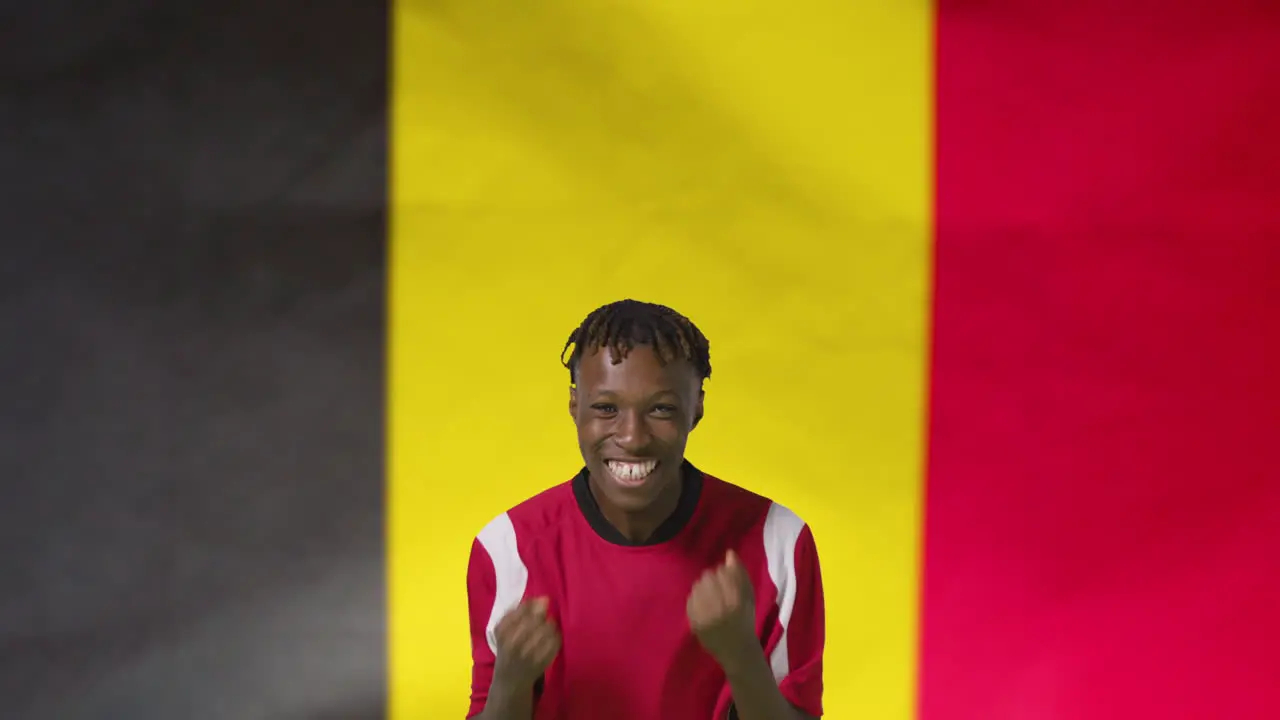 Young Footballer Celebrating to Camera In Front of Belgium Flag 01