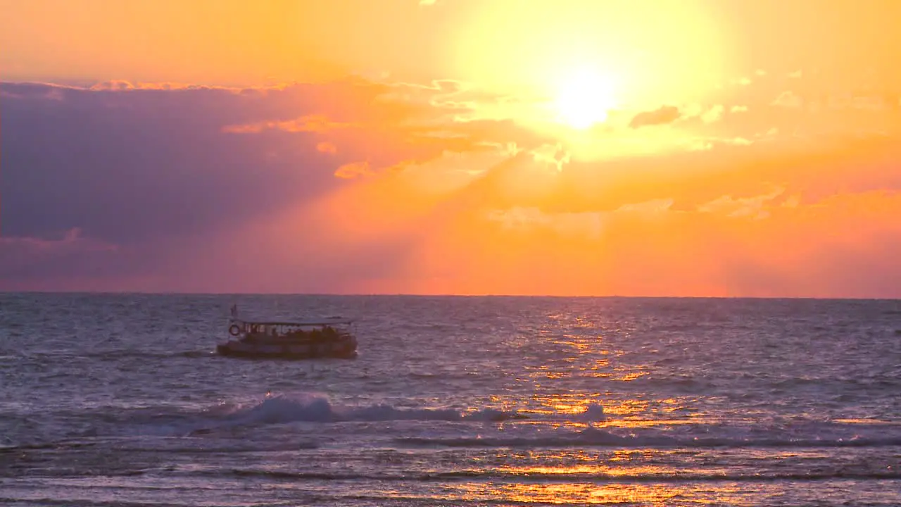 A fishing boat heads into the sunset on the Mediterranean Sea